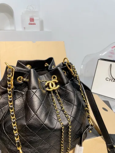 The Chanel bucket bag features a soft leather body and a shoulder strap, exuding a casual and elegant scent