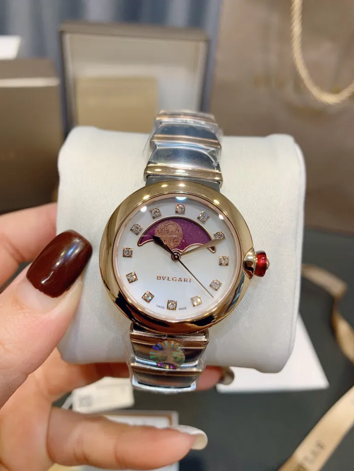 The Bulgari moon phase watch features a curved moon phase window placed above the mother of pearl dial, adding visual balance to the watch's design. Imported Sun Moon Star Quartz Movement,