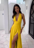 Solid-color maxi dress with a halter V-neck and side slit.