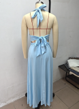 Solid-color maxi dress with a halter V-neck and side slit.