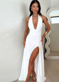 Solid-color maxi dress with a halter V-neck and side slit.