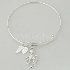 A wire bracelet with one big metal charms and two small charms