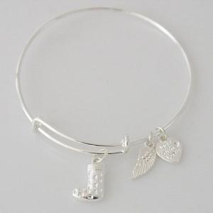 A wire bracelet with one big metal charms and two small charms