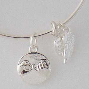 A wire bracelet with one big metal charms mother