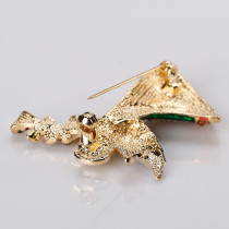 Christmas brooch with angel blowing trumpet