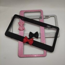 Bow shaped acrylic diamond studded US standard stainless steel license plate frame