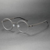 Olet Optical's LE0244 circle frame glasses, showcasing an elegant gunmetal titanium frame with a sophisticated gray acetate inner rim and a sleek no-screw design, equipped with adjustable nose pads for superior comfort and style.