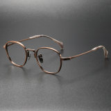 Olet Optical's LE0150 large round glasses in bronze, featuring hypoallergenic titanium frames with white tortoiseshell temple tips for a refined look.

