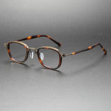 Olet Optical's LE0448 tortoiseshell glasses in TortoiseShell and bronze, featuring acetate oval frames with hypoallergenic bronze titanium detailing for a refined look.