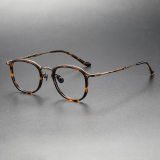 Olet Optical's LE0414 round tortoise eyeglasses, featuring TortoiseShell acetate frames with segmented bronze titanium temples for a stylish, hypoallergenic finish.

