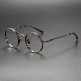 Olet Optical's LE0408 bronze glasses, uniquely accented with black details on a hypoallergenic titanium frame, perfect for sophisticated wear.


