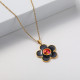 collar surfero oro 18k con dije flosita negra piedras