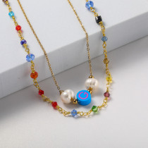 collar en doble cadena con perla natural y charm azul piedras