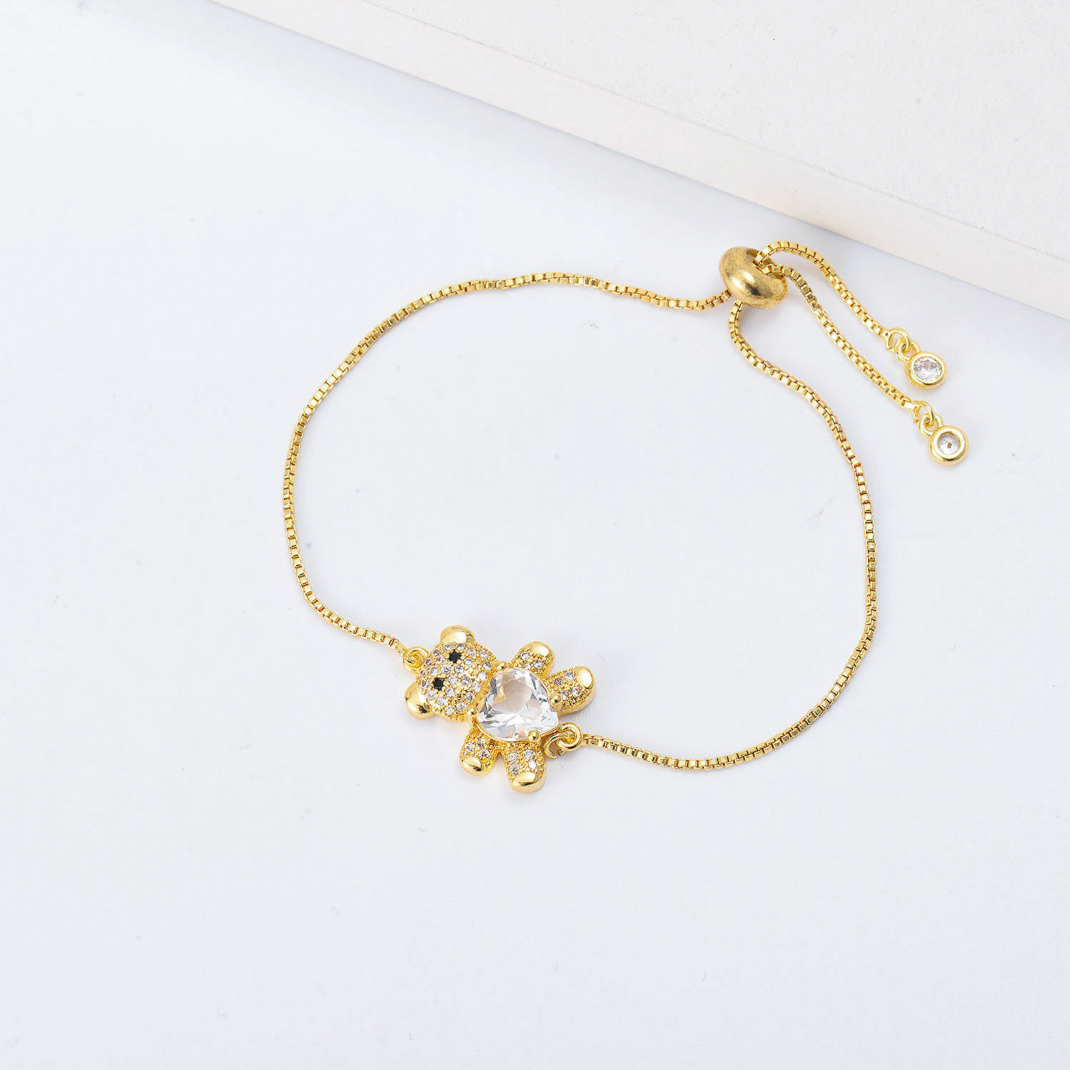 pulsera de osito con piedra blanca dolor dorado