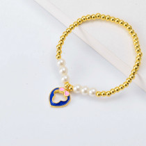 Pulseras bolitas Oro Laminado con corazon corbata de moño y perlas