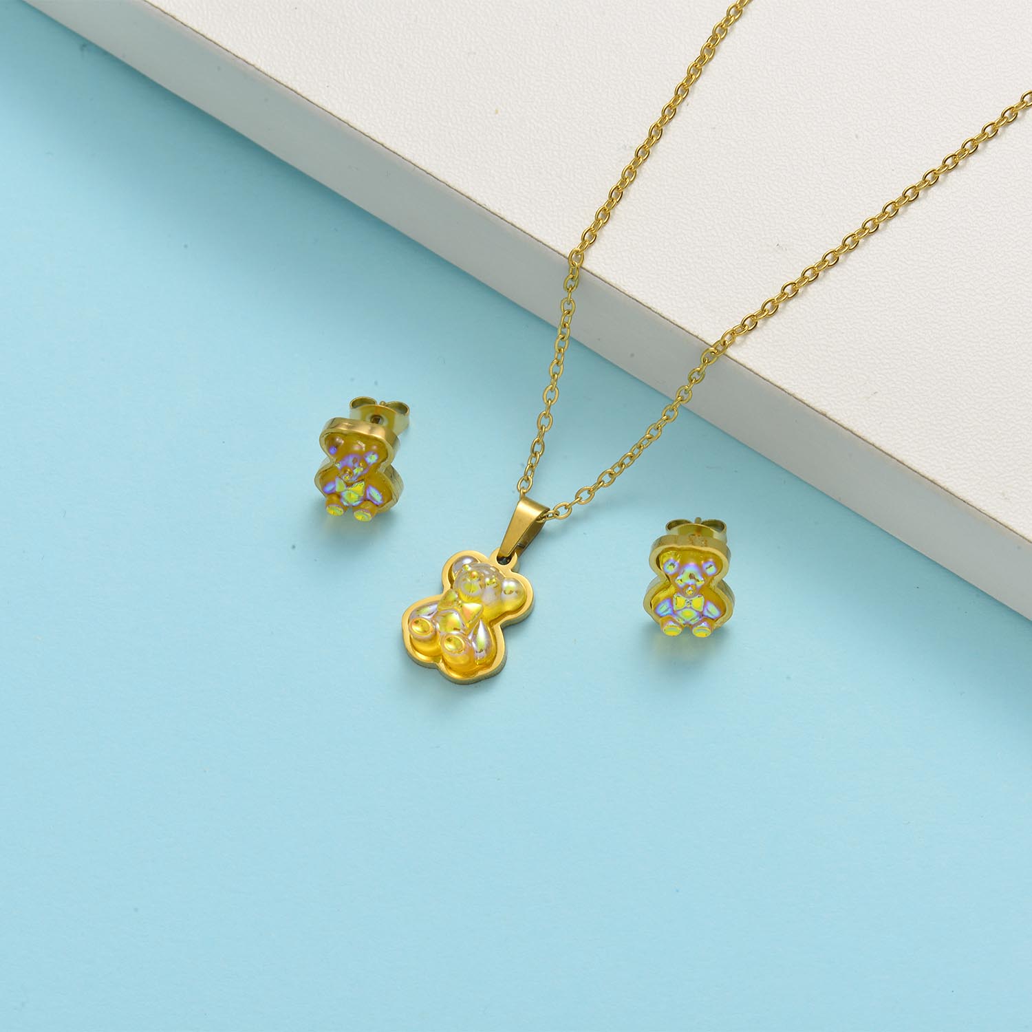 conjunto de acero con arete para mujer con dije de osito amarillo