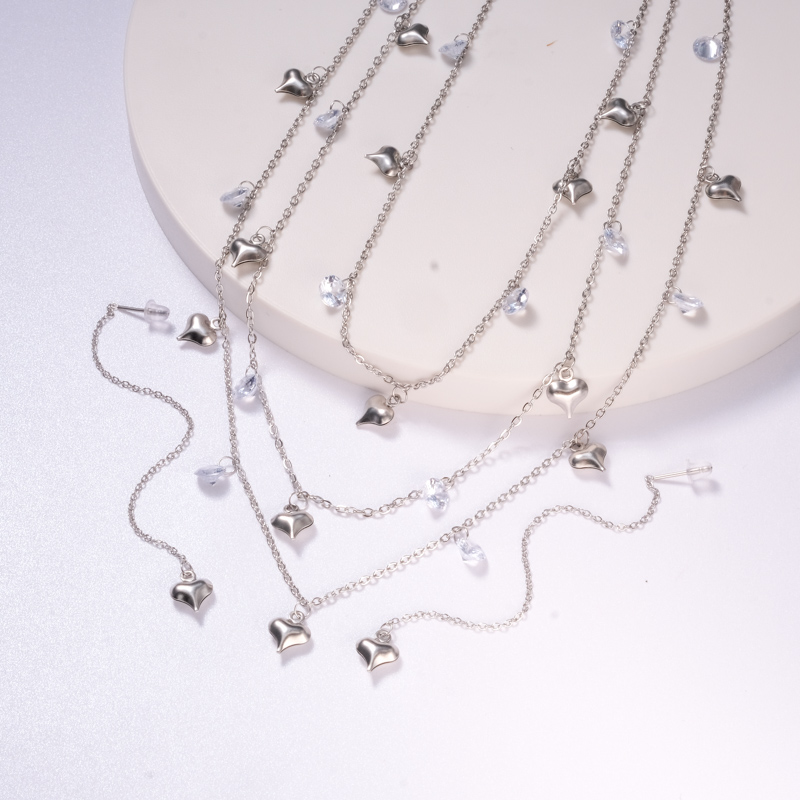 conjuntos estilo nuevo con aretes de acero corazoncito y piedras color silver para mujer
