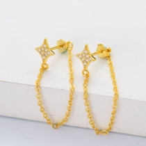aretes de estrella plata 925 de cuatro puntas  con cadenita piedras color dorado para mujer