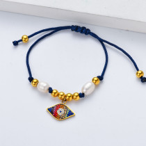 pulsera de hilo azul con fatima de ojo rojo y perla natural