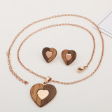 Joyería al por mayor determinada del collar de los pendientes en forma de corazón de madera del acero titanio de la moda
