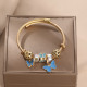 Brazalete hueco esmaltado de acero inoxidable con mariposa dulce linda