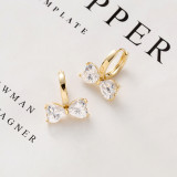 1 par de pendientes de diamantes con incrustaciones de cobre y nudo de lazo a la moda