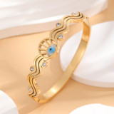 Brazalete chapado en oro con diamantes de imitación con incrustaciones de epoxi y acero de titanio con ojo artístico