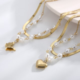 Collar elegante de las pulseras de la galjanoplastia de acero del titanio de la perla de agua dulce de la forma del corazón