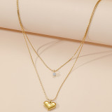 Collar chapado en oro de 18 quilates con incrustaciones de pulido de acero de titanio con forma de corazón brillante elegante