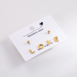 1 Juego de pendientes elegantes de acero inoxidable con llave de mariposa y cara sonriente para mujer