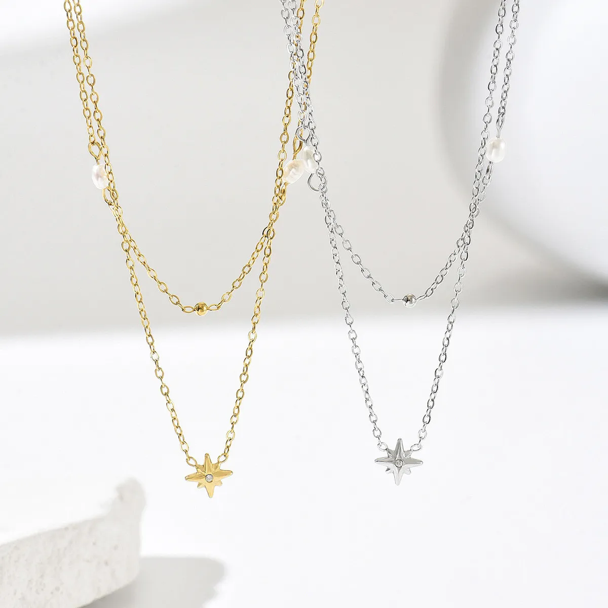 Layered starburst pearl titanium steel double-layer necklace in gold and silver, niche collarbone chain for everyday workplace elegance