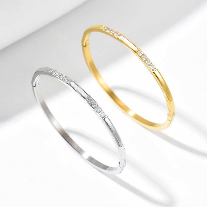 Luxurious diamond-encrusted thin bangle in two-tone titanium steel, unique segmented design with full diamond inlay, non-repetitive and versatile