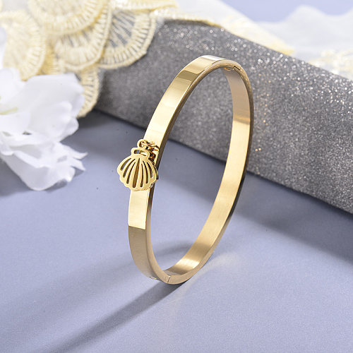Golden stainless steel solid bracelet with hollow shell pendant