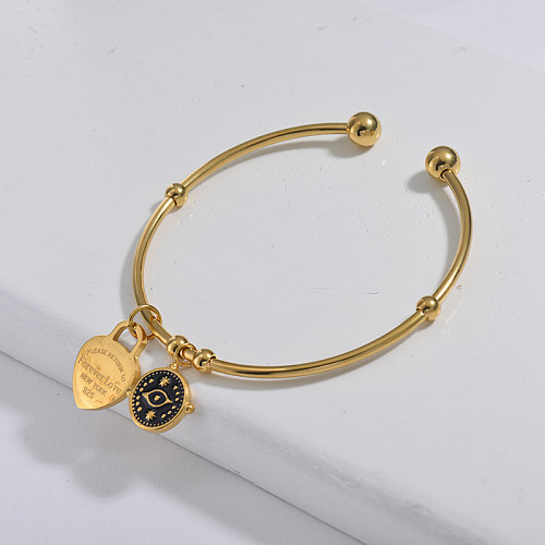 Simple style golden stainless steel bracelet with black dripping evil eye pendant