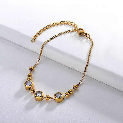 Gold stainless steel steel ball bracelet with red zircon pendant