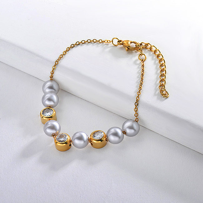 Golden stainless steel bracelet separated by pearl and zircon