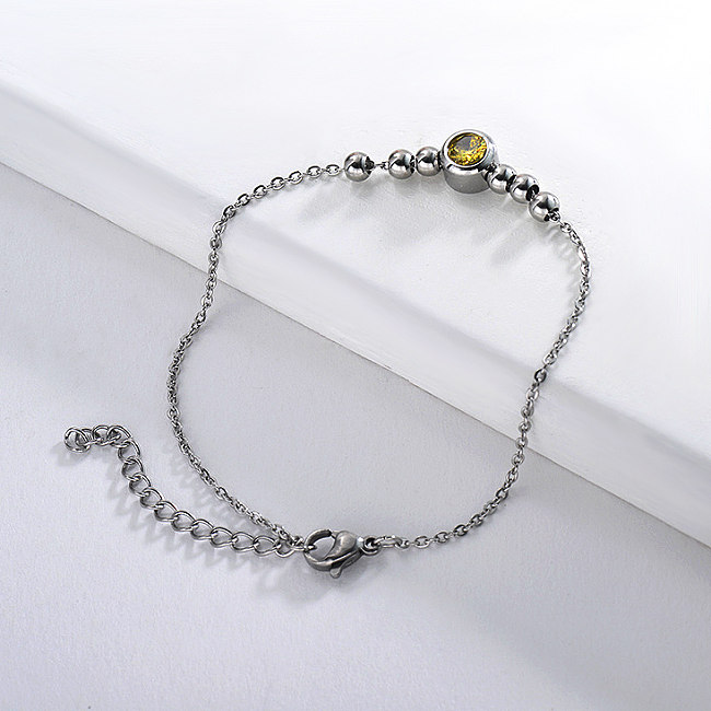 Stainless steel ball bracelet with yellow zircon pendant