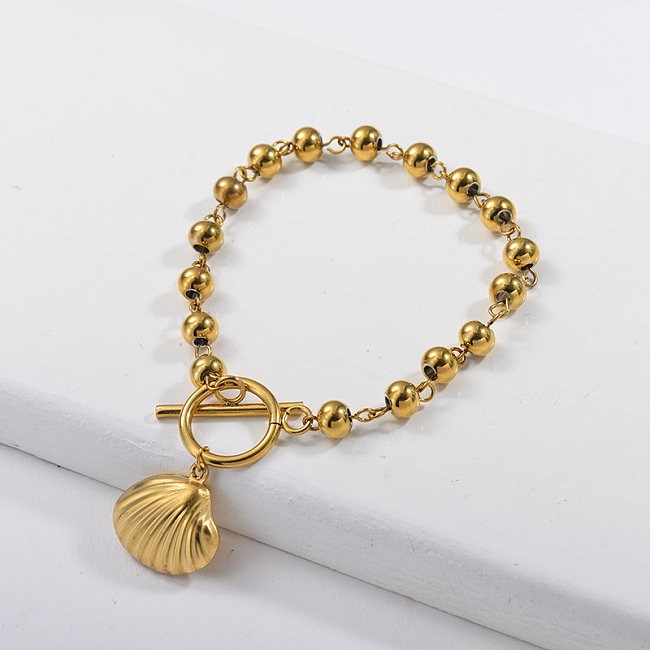 pulseira de bola de aço inoxidável cor ouro e pingente concha