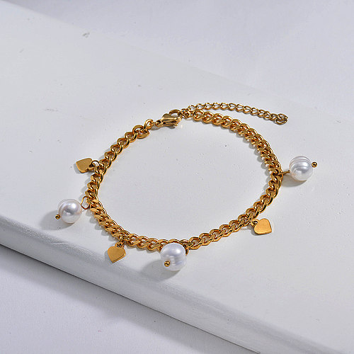 A pulseira de ouro de aço inoxidável com um estilo de corrente polida com pérolas de água doce é separada do pingente de coração