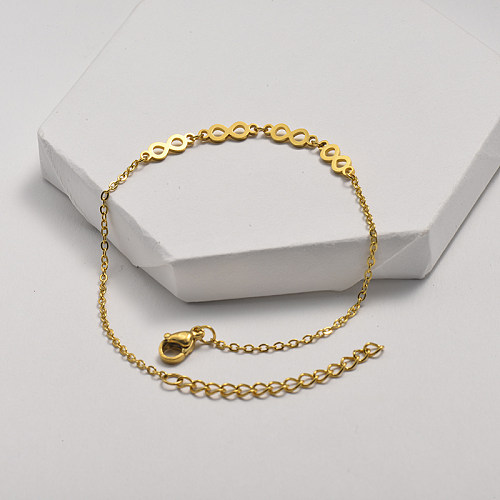 Golden stainless steel bracelet with cut-out figure-of-eight pendant