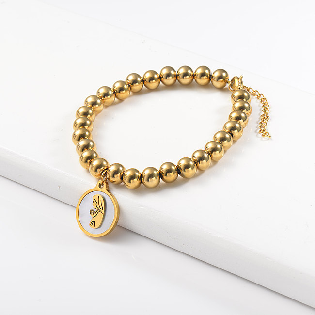 Stainless steel golden steel ball bracelet with white shell pendant