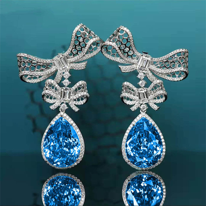 Arete de diamante y topacio azul para mujer