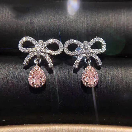 Bonitos aretes de cuarzo rosa con lazo de diamantes para mujer