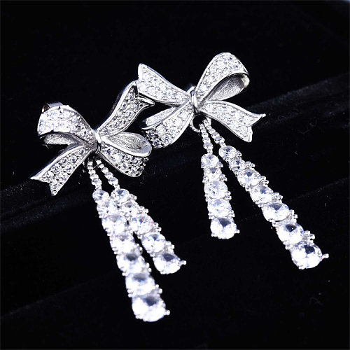 Aretes de lazo de diamantes simples para mujer