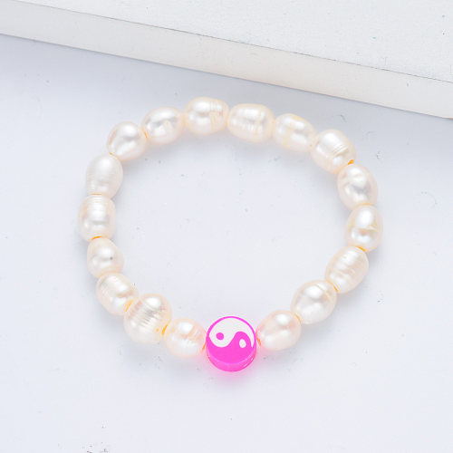 women bracelet with white pearl and pink pendant