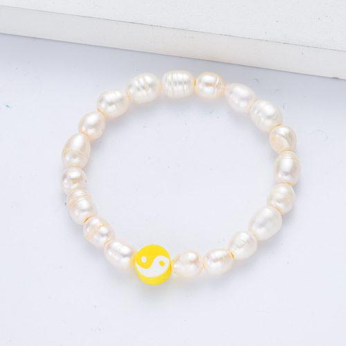female bracelet with white pearl and pink pendant