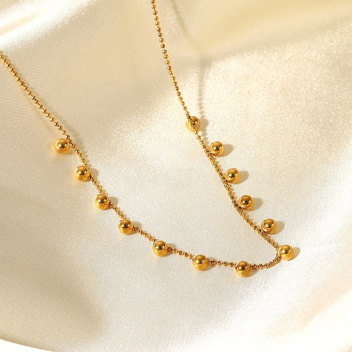 Collier en acier inoxydable plaqué or 18 carats avec pompon et petites perles