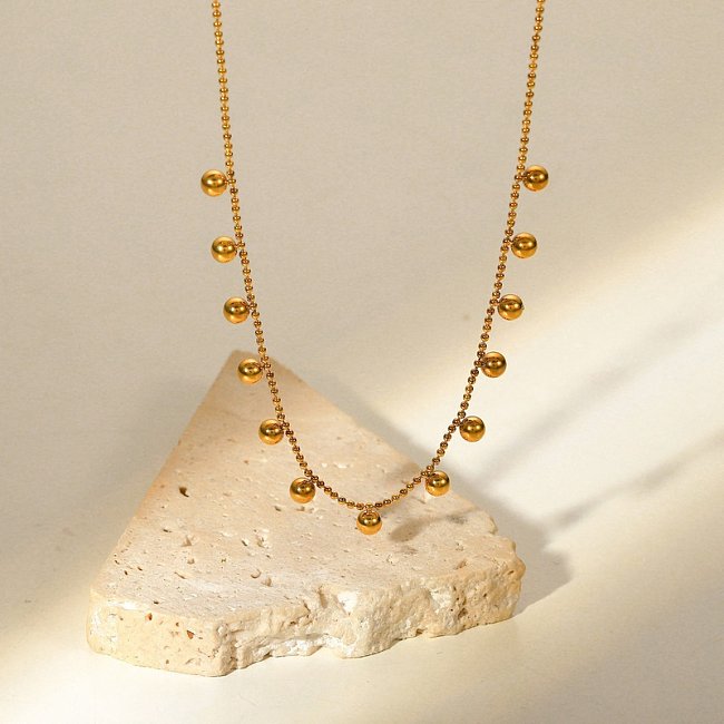 Collier en acier inoxydable plaqué or 18 carats avec pompon et petites perles