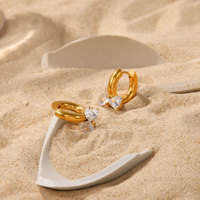 Pendientes chapados en oro de acero inoxidable con forma de lazo de corazón doble blanco de estilo de moda