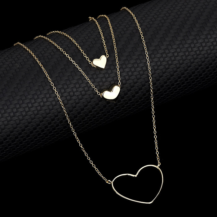 Collier superposé avec pendentif triple cœur en argent sterling
